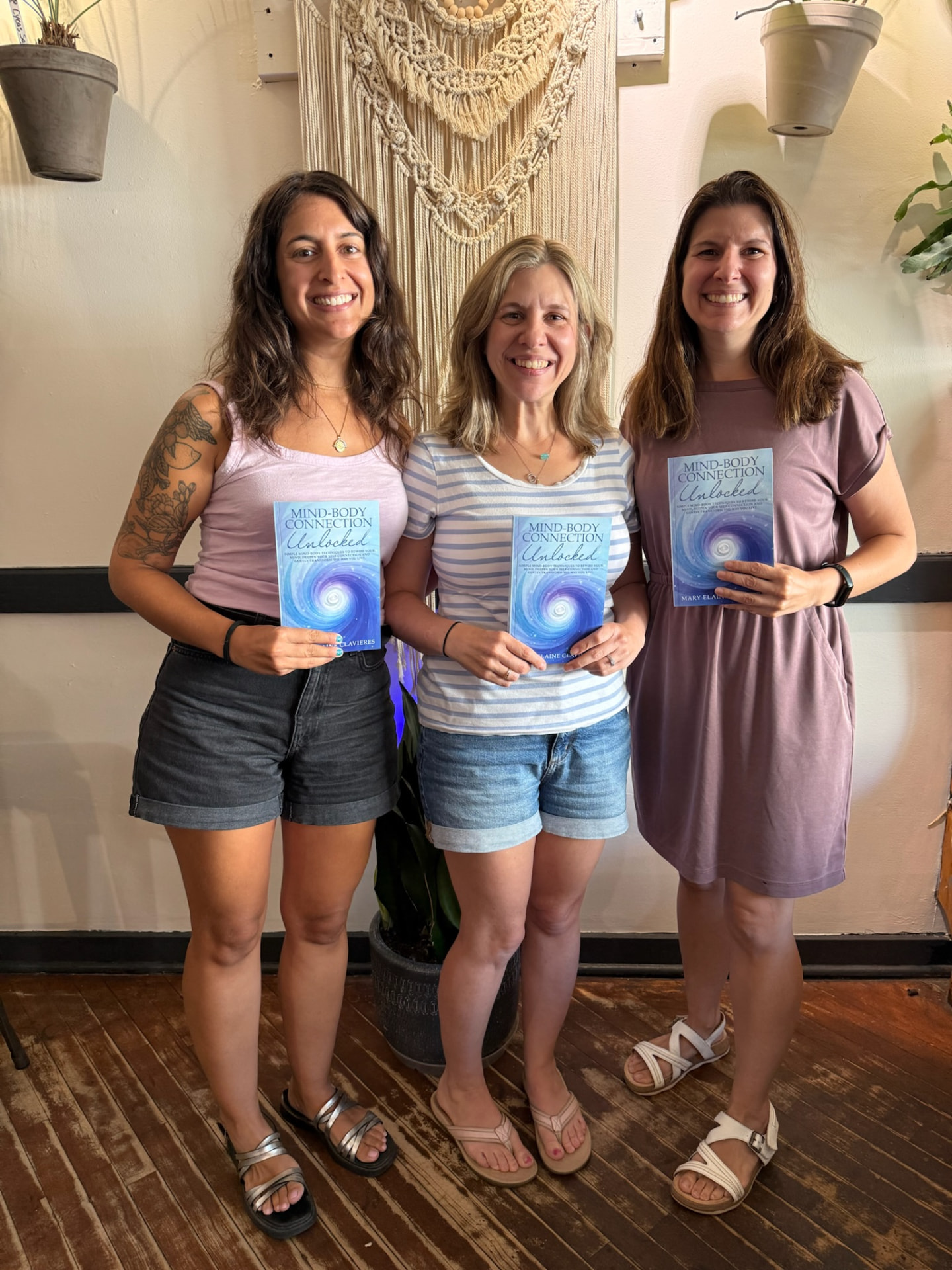 Mary with two readers holding Mind-Body Connection Unlocked