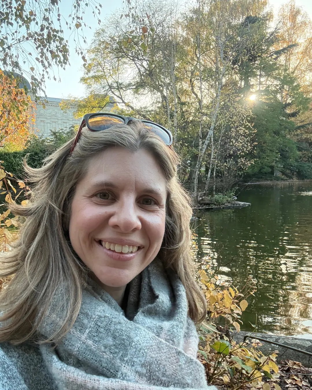 Mary beside a pond in autumn light